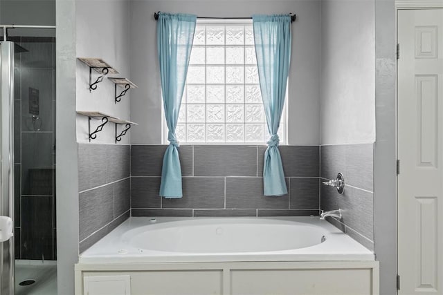 bathroom with a garden tub and a stall shower