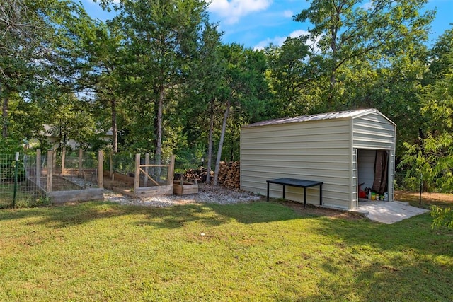 view of yard with an outbuilding, a storage shed, and a vegetable garden