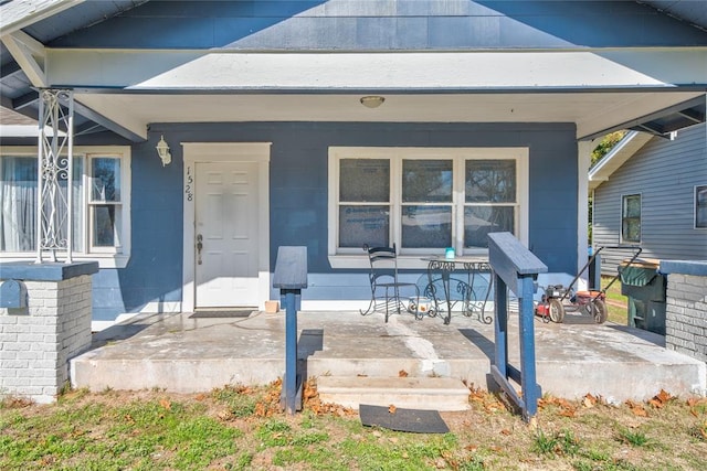 view of exterior entry featuring a porch