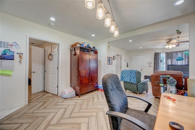 office area with light parquet floors and ceiling fan