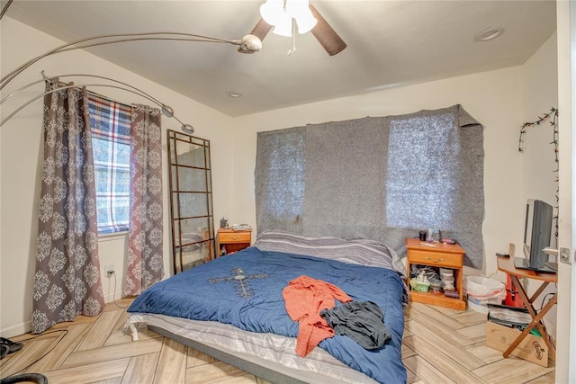 bedroom with ceiling fan and light parquet floors