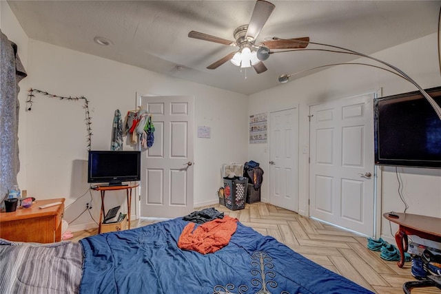 bedroom with ceiling fan and light parquet floors