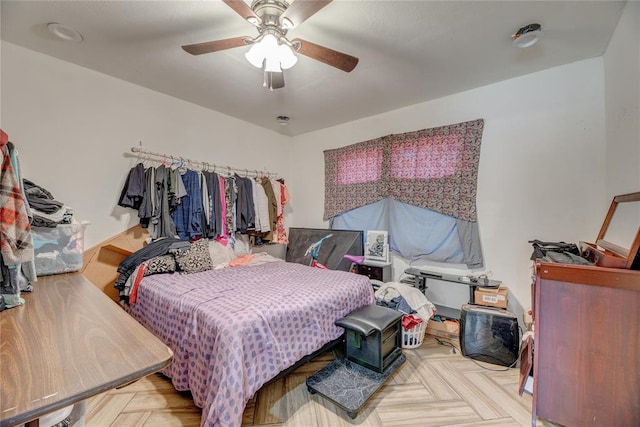 bedroom featuring ceiling fan and light parquet floors