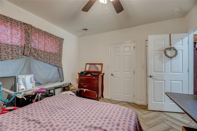 bedroom featuring ceiling fan and light parquet floors