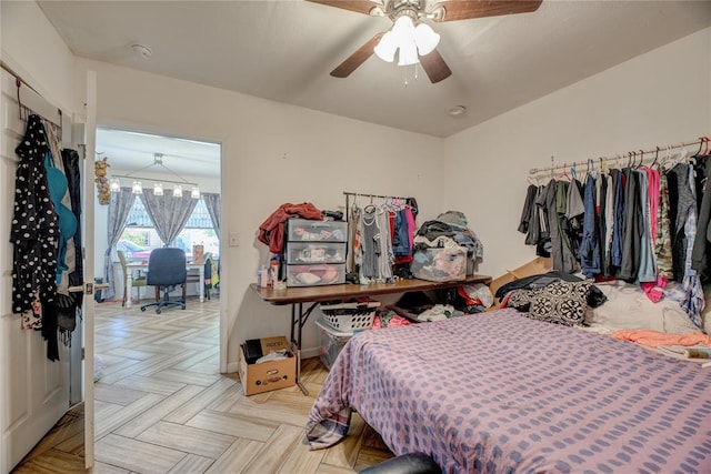 bedroom with ceiling fan and light parquet floors