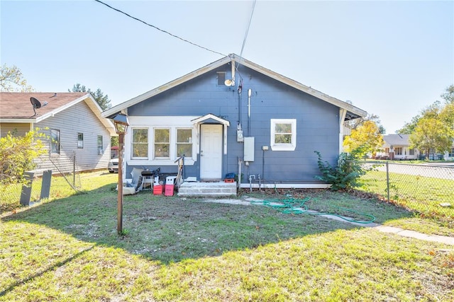 rear view of house with a yard