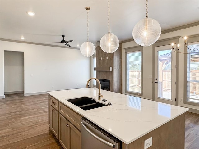 kitchen with dark hardwood / wood-style flooring, dishwasher, a center island with sink, and sink