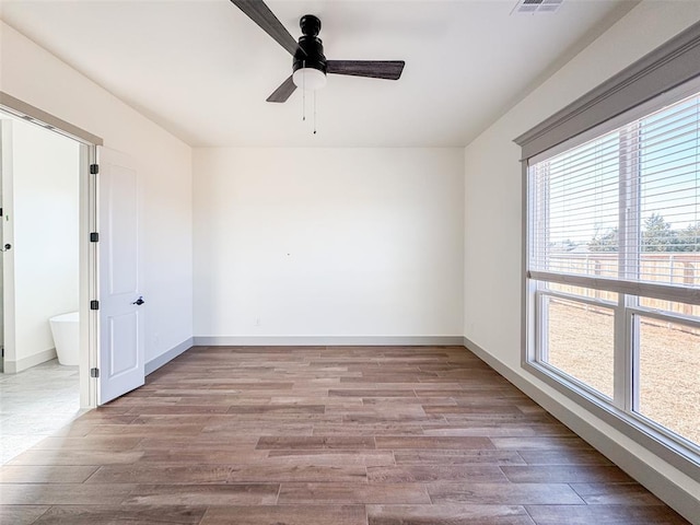 empty room featuring light hardwood / wood-style flooring and ceiling fan