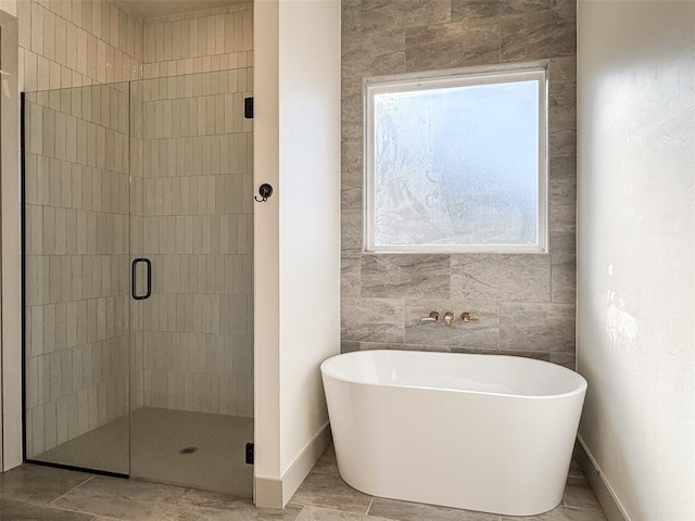 bathroom featuring separate shower and tub