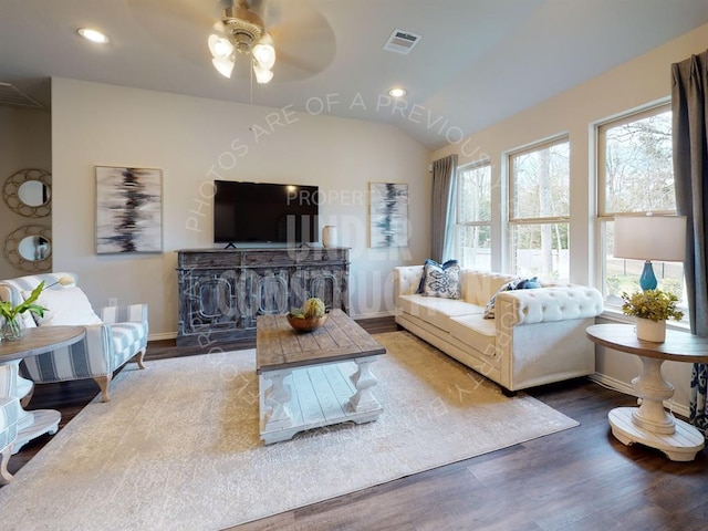 living room with hardwood / wood-style floors, vaulted ceiling, and ceiling fan