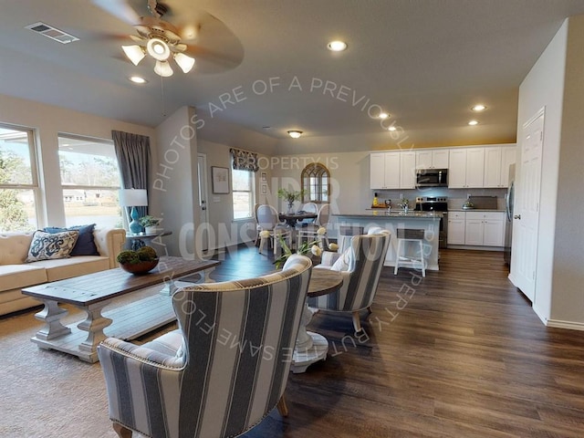 dining room with ceiling fan, a healthy amount of sunlight, and dark hardwood / wood-style floors