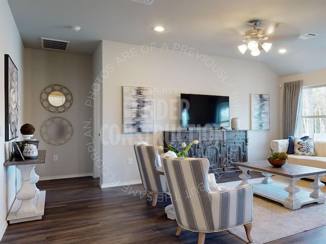 living room featuring ceiling fan, dark hardwood / wood-style flooring, and lofted ceiling