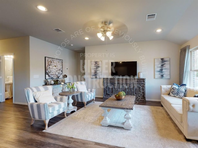 living room with ceiling fan, wood-type flooring, and lofted ceiling