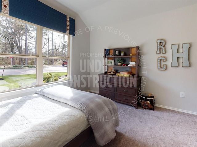 carpeted bedroom with vaulted ceiling