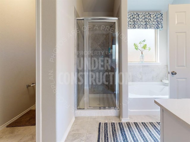 bathroom featuring tile patterned floors, plus walk in shower, and vanity