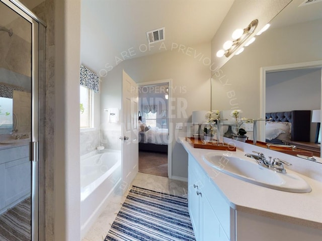 bathroom featuring a tub to relax in, tile patterned flooring, vanity, and vaulted ceiling