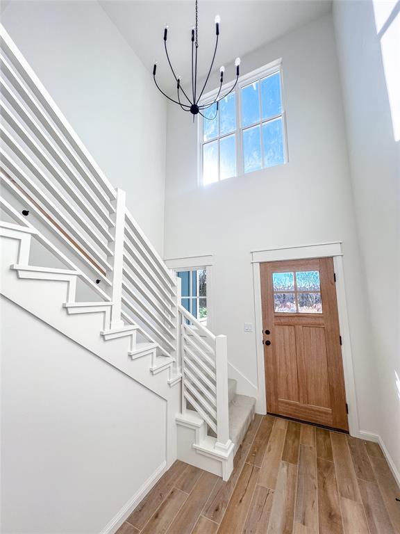 entrance foyer featuring a wealth of natural light, a chandelier, and light hardwood / wood-style flooring