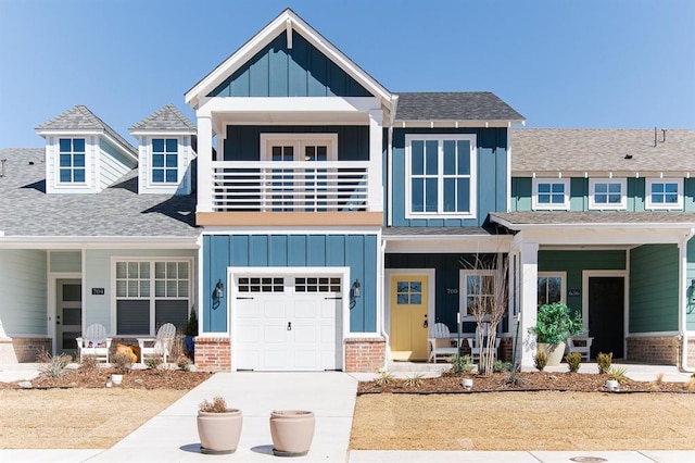 view of front of house with a balcony, a porch, board and batten siding, and brick siding