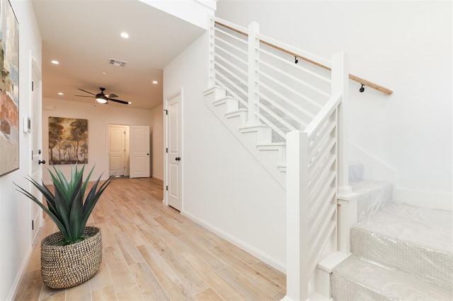 staircase featuring baseboards, visible vents, ceiling fan, wood finished floors, and recessed lighting