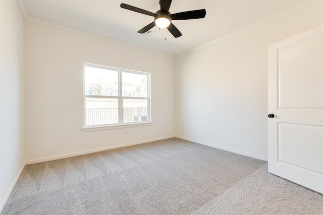 unfurnished room featuring baseboards, carpet floors, a ceiling fan, and crown molding