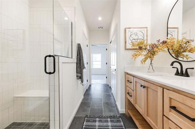 bathroom featuring visible vents, a shower stall, vanity, and baseboards