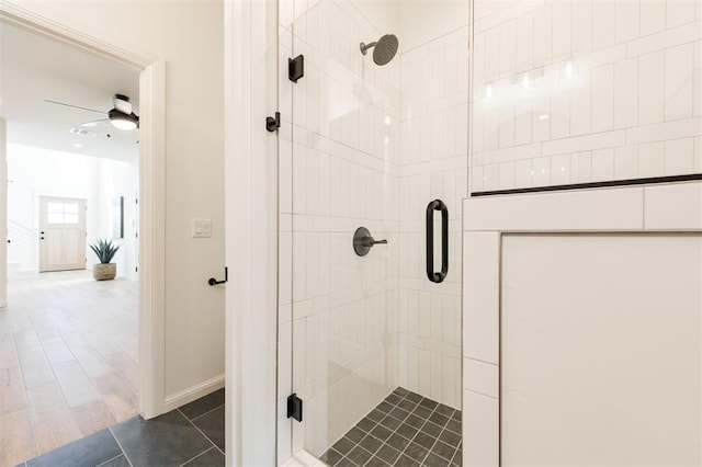 bathroom with a ceiling fan, a stall shower, and visible vents