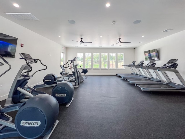 gym with baseboards, visible vents, and a ceiling fan