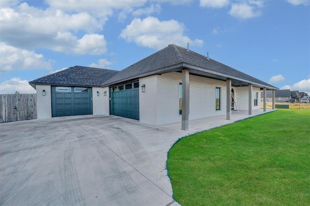 view of side of home featuring a garage and a yard