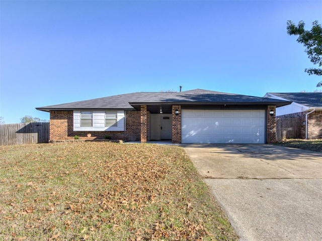 ranch-style home featuring a garage and a front lawn