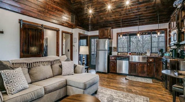 living room with a towering ceiling, wood ceiling, sink, a barn door, and dark hardwood / wood-style floors