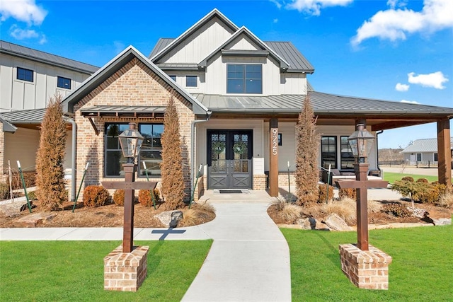 view of front of property with a front lawn and french doors