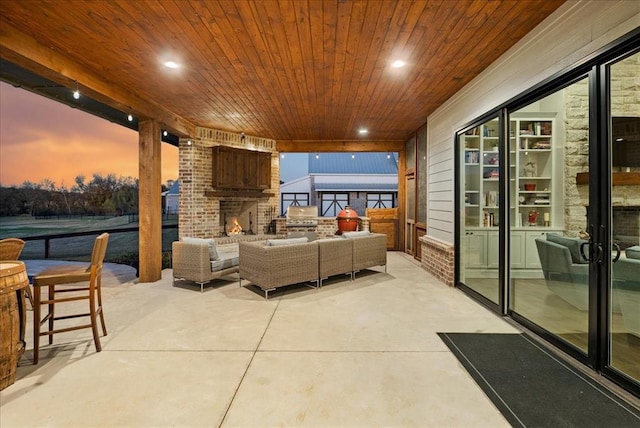 patio terrace at dusk featuring an outdoor living space with a fireplace