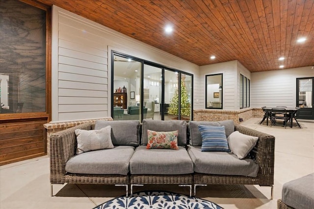 living room with wooden walls and wooden ceiling