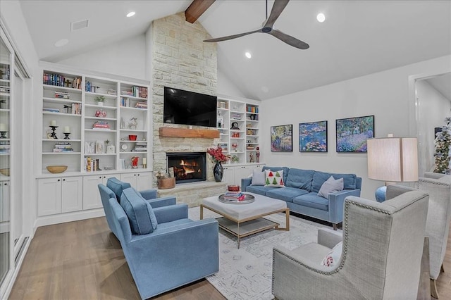 living room with high vaulted ceiling, a fireplace, beamed ceiling, ceiling fan, and light wood-type flooring