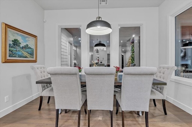 dining area with hardwood / wood-style floors