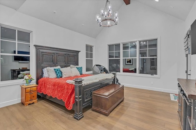 bedroom featuring beam ceiling, high vaulted ceiling, an inviting chandelier, and light hardwood / wood-style flooring