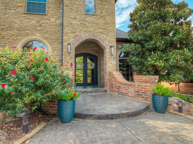 view of exterior entry featuring french doors