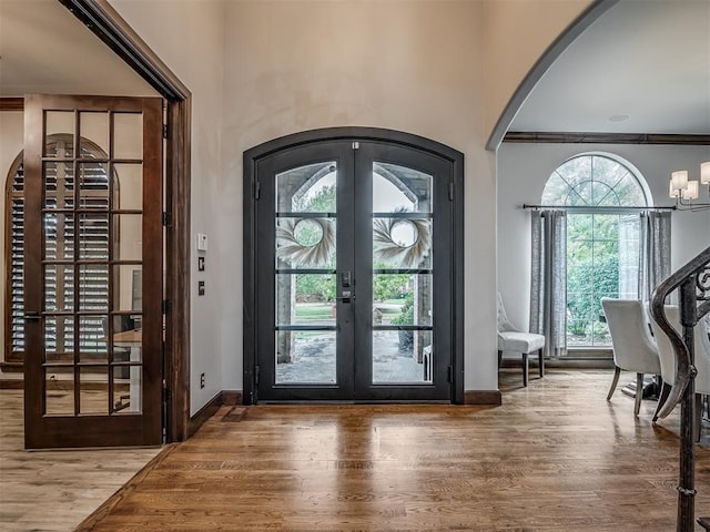 doorway to outside featuring french doors, a healthy amount of sunlight, and hardwood / wood-style flooring