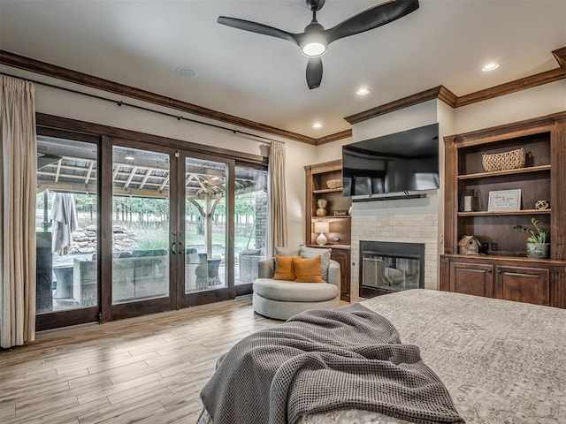 bedroom with access to outside, multiple windows, ceiling fan, and light hardwood / wood-style floors