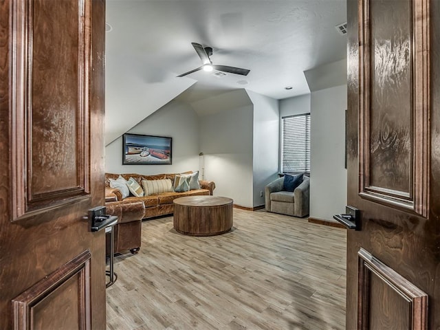 interior space with ceiling fan, light hardwood / wood-style flooring, and lofted ceiling