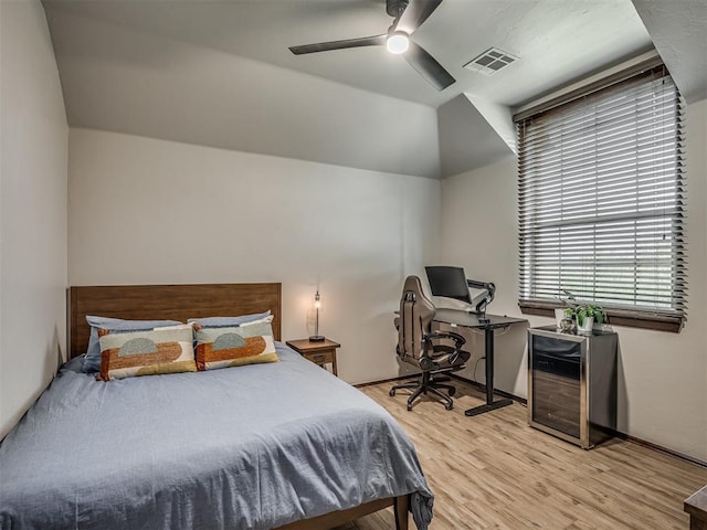 bedroom featuring ceiling fan, lofted ceiling, and light hardwood / wood-style flooring