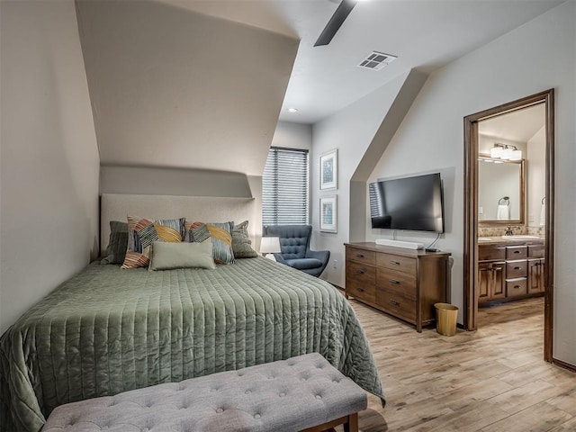 bedroom featuring ensuite bathroom, ceiling fan, sink, and light hardwood / wood-style flooring