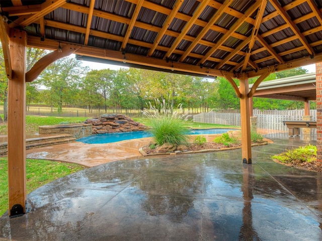 view of patio with a fenced in pool and a gazebo