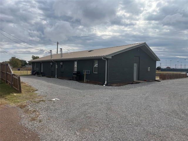 701 N Park Ln, Altus, OK 73521 - rear view of house featuring metal roof and cooling unit