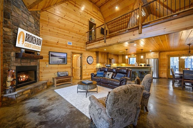 living room with beam ceiling, wooden ceiling, a stone fireplace, high vaulted ceiling, and wood walls