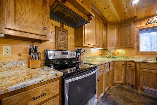 kitchen featuring electric range, custom exhaust hood, and light stone countertops