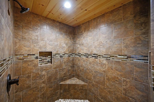 bathroom featuring tiled shower and wood ceiling