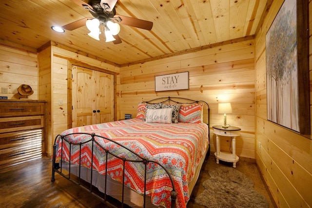 bedroom with wooden walls, ceiling fan, and wood ceiling