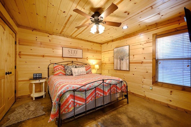 bedroom with wood walls, ceiling fan, and wood ceiling