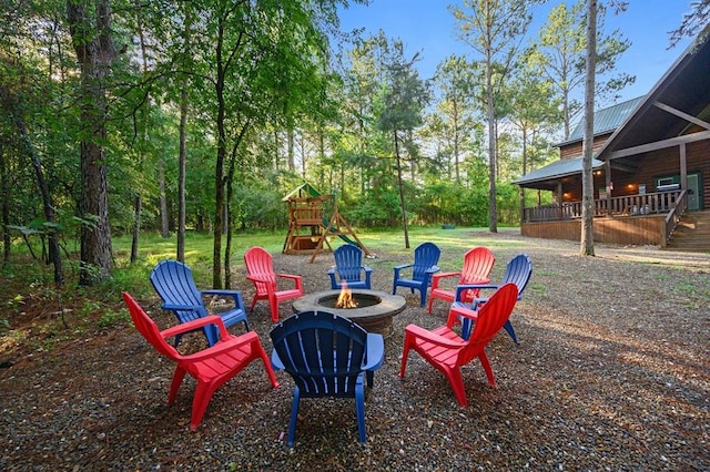 view of patio / terrace featuring a playground and an outdoor fire pit